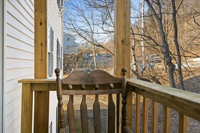 a front view of a house with a tree