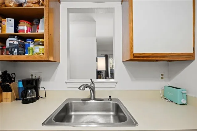 a kitchen with a sink and a window