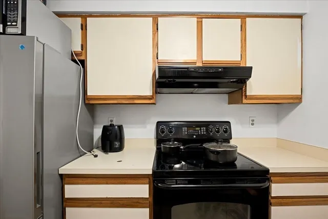 a kitchen with a stove and a microwave