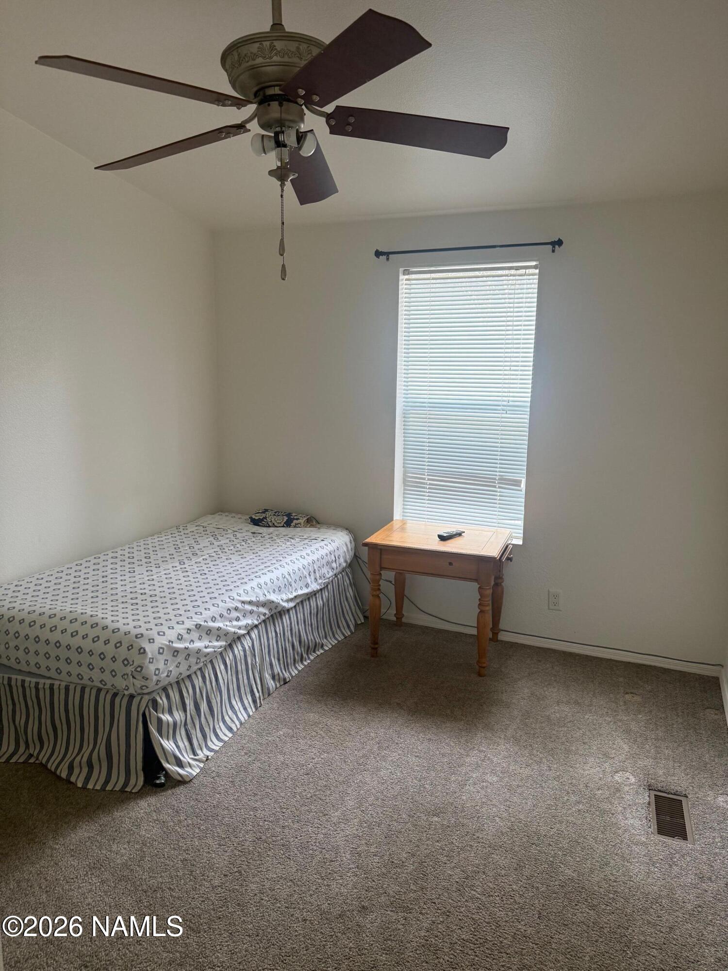 17075 Grizzly Ridge Munds Park, AZ 86017 - Photo 24 of 31 a bedroom with a bed and a table