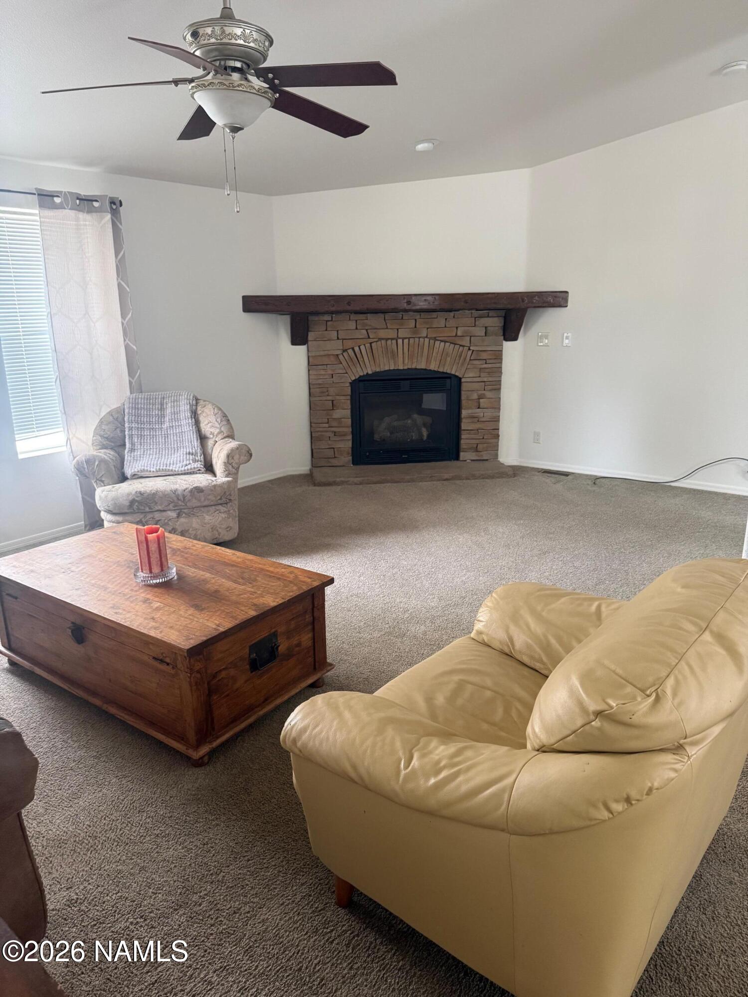 17075 Grizzly Ridge Munds Park, AZ 86017 - Photo 5 of 31 a living room with furniture and a fireplace