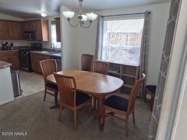 17075 Grizzly Ridge Munds Park, AZ 86017 - Photo 8 of 31 a view of a dining room with furniture a chandelier and wooden floor