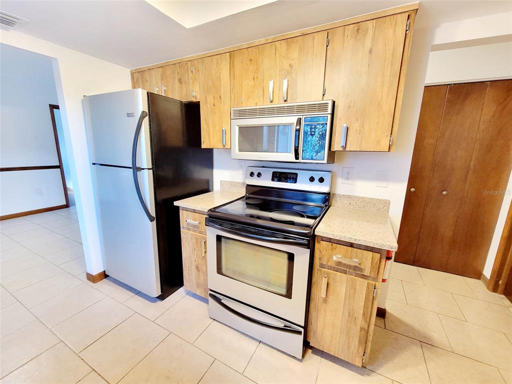 9760 Southwest 101st Lane Ocala, FL 34481 - Photo 2 of 17 a kitchen with stainless steel appliances a stove a refrigerator and a cabinets