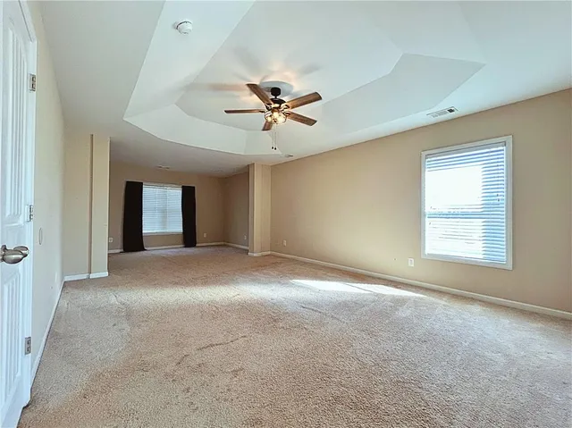 a view of a livingroom with a ceiling fan and window