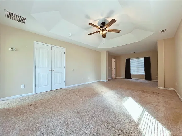 a view of a livingroom with a ceiling fan and window