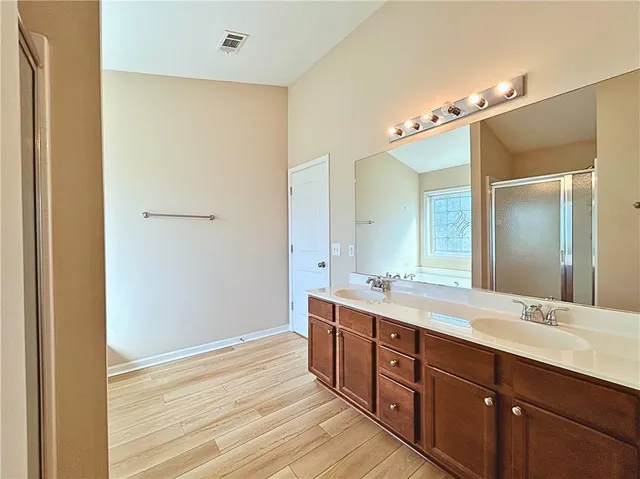a spacious bathroom with a double vanity sink and a mirror
