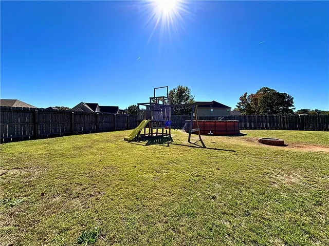 a swimming pool with wooden fence