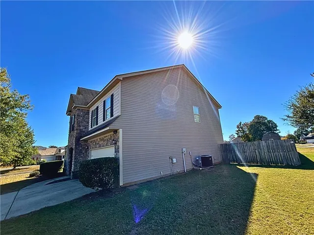 a backyard of a house with wooden fence