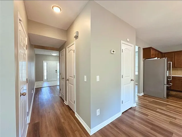 a view of hallway with wooden floor