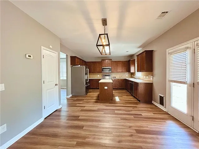 a view of kitchen with wooden floor