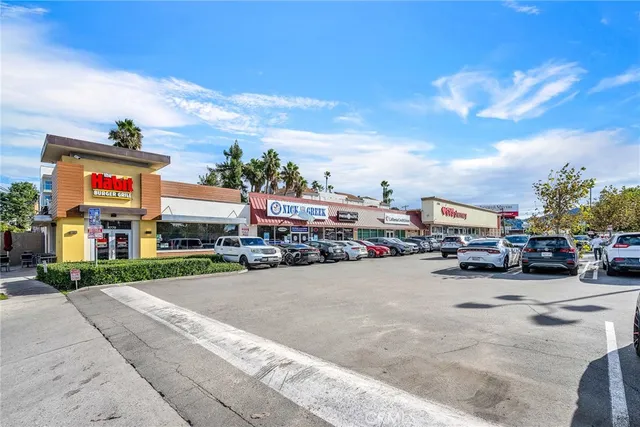 a view of street with parked cars