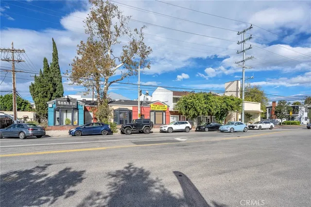 a view of a street with cars on the road