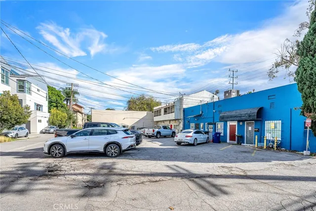a view of a cars park in front of a building