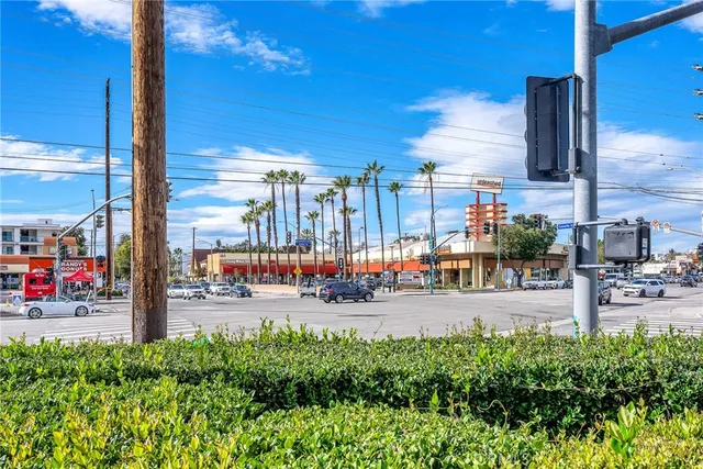 a street view with tall buildings and a cars park