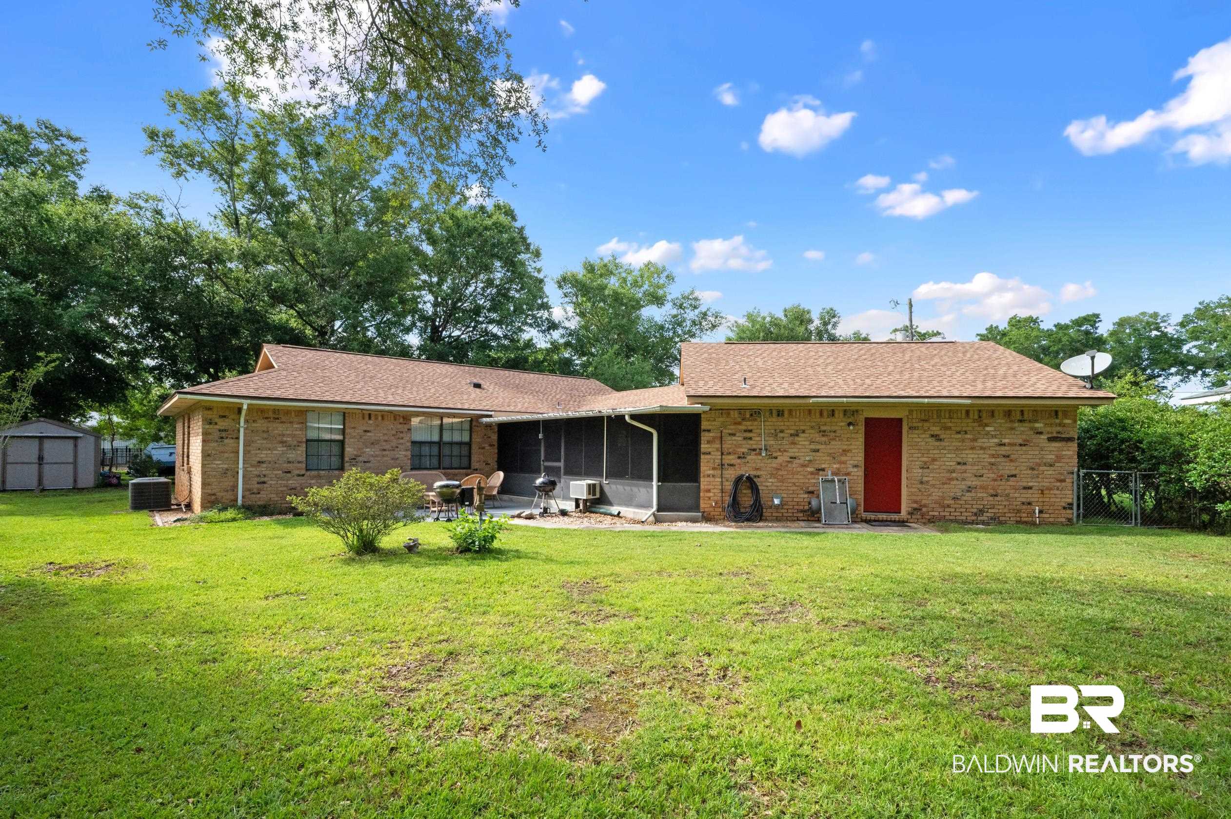 2772 Santa Rosa Circle Lillian, AL 36549 - Photo 32 of 50 Rear view of property with a patio, a storage unit, a lawn, and cooling unit
