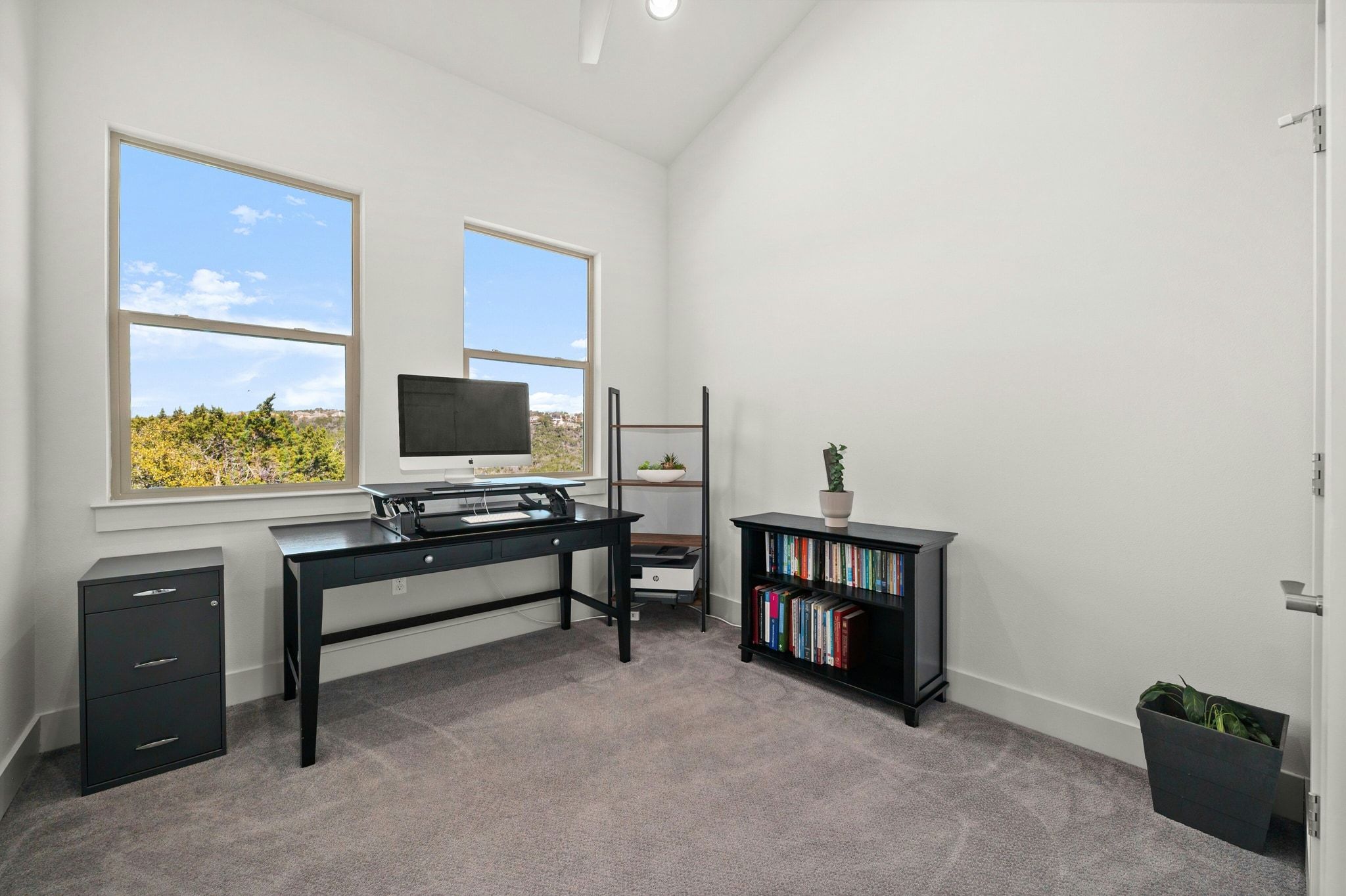 8110 Ranch Road 2222, Unit 92 Austin, TX 78730 - Photo 22 of 40 Bright room featuring two large windows, neutral-toned carpeting, high ceilings, and a ceiling fan light fixture