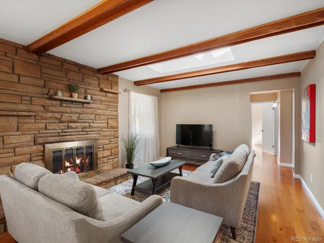 a dining room with furniture and a large window