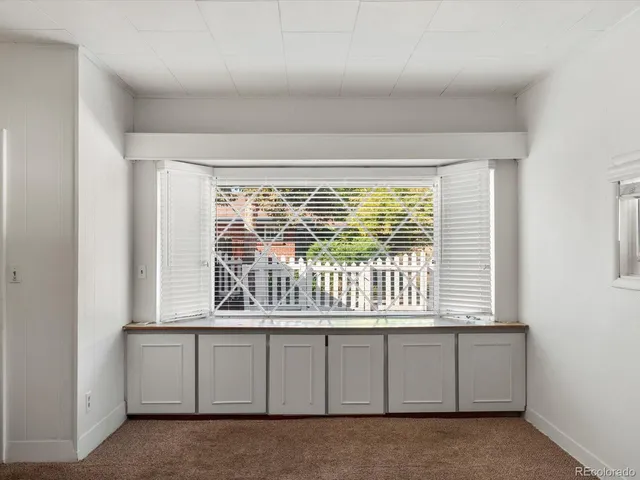 an empty room with furniture and ceiling fan