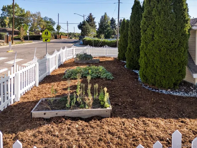 a view of a yard with wooden fence