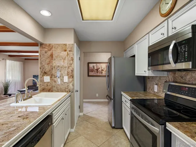 a kitchen with stainless steel appliances granite countertop a stove and a microwave
