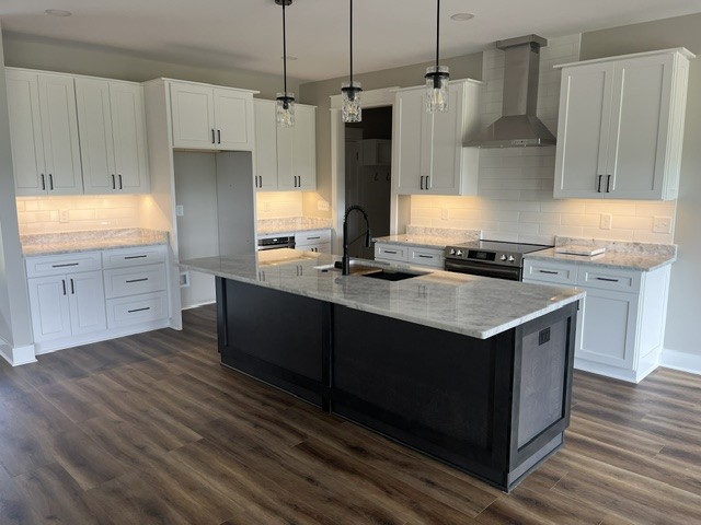 8246 Aedc Road Estill Springs, TN 37330 - Photo 55 of 55 a kitchen with kitchen island granite countertop a sink stove and refrigerator