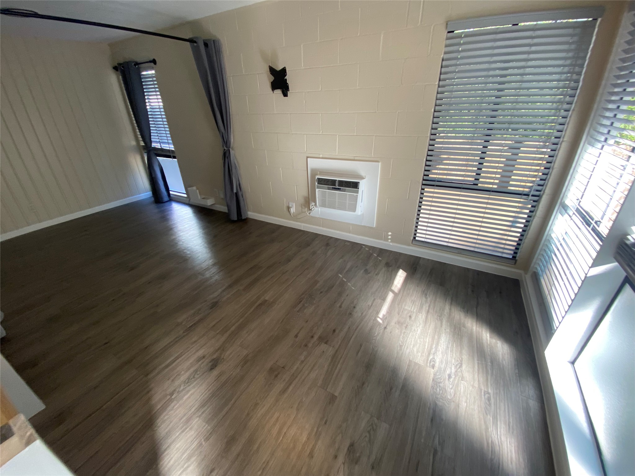 3010 Fruth Street, Unit B Austin, TX 78705 - Photo 7 of 32 Laminate flooring and a wall unit cooling system enhance this functional room.