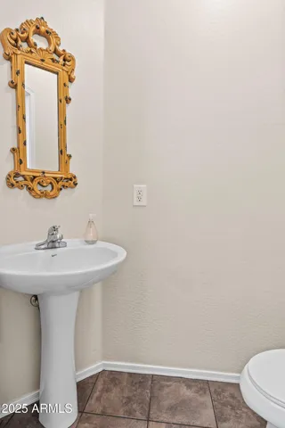 a bathroom with a sink a toilet and mirror