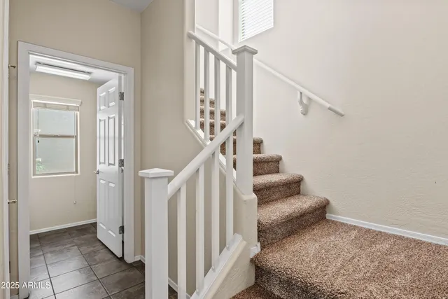 a view of entryway bedroom and hall with wooden floor