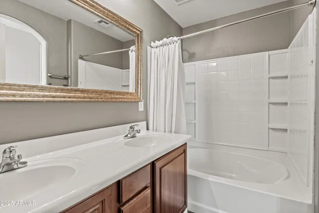 a bathroom with a tub sink and mirror