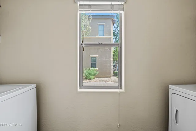 a view of a hallway with a washer and dryer