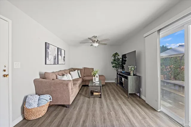 a living room with furniture and wooden floor