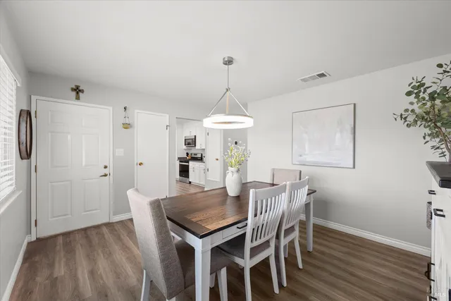 a view of a dining room with furniture window and wooden floor