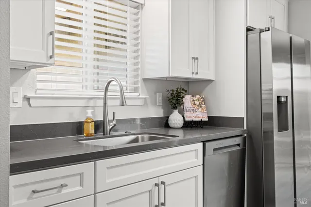 a kitchen with appliances cabinets and a sink