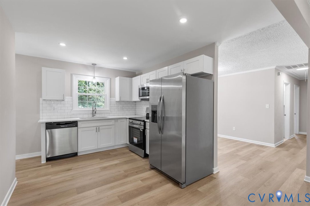 3308 Sylvania Road Chester, VA 23831 - Photo 11 of 55 Kitchen featuring white cabinetry, stainless steel