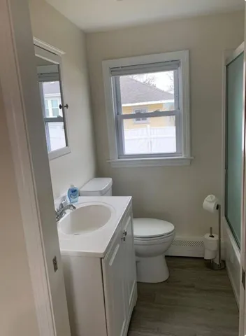 a bathroom with a toilet sink and mirror