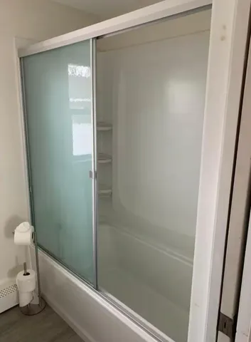 a bathroom with a shower and a toilet