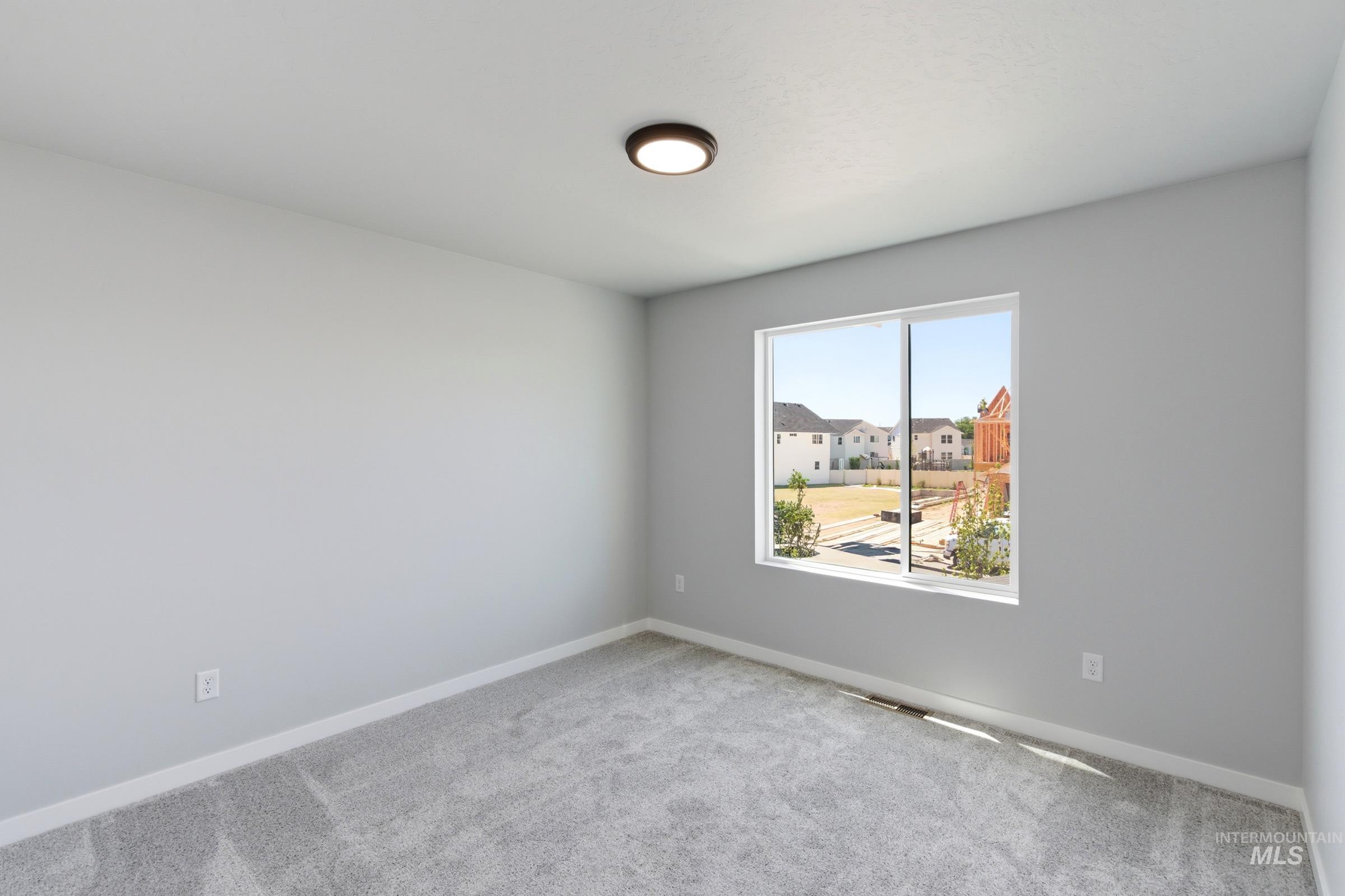 2374 West Fallon Loop Nampa, ID 83651 - Photo 14 of 24 Spacious room featuring light gray walls, gray carpet flooring, and a large window