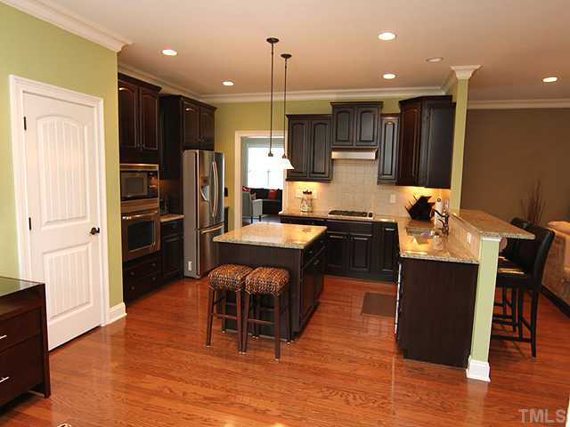 Another view of this spectacular kitchen, that is open to both the family room and breakfast nook. Hardwood floors and custom crown molding also add to the charm! Kitchen