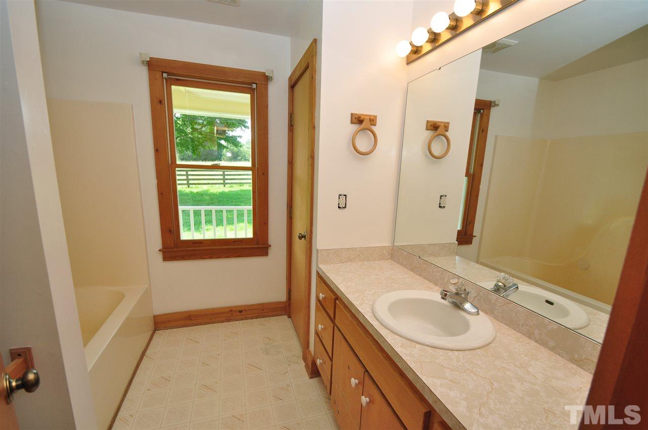 738 Castle Rock Farm Road Pittsboro, NC 27312 - Photo 15 of 25 a bathroom with a sink and a mirror