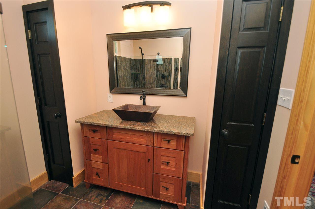 738 Castle Rock Farm Road Pittsboro, NC 27312 - Photo 21 of 25 a bathroom with a sink and a mirror