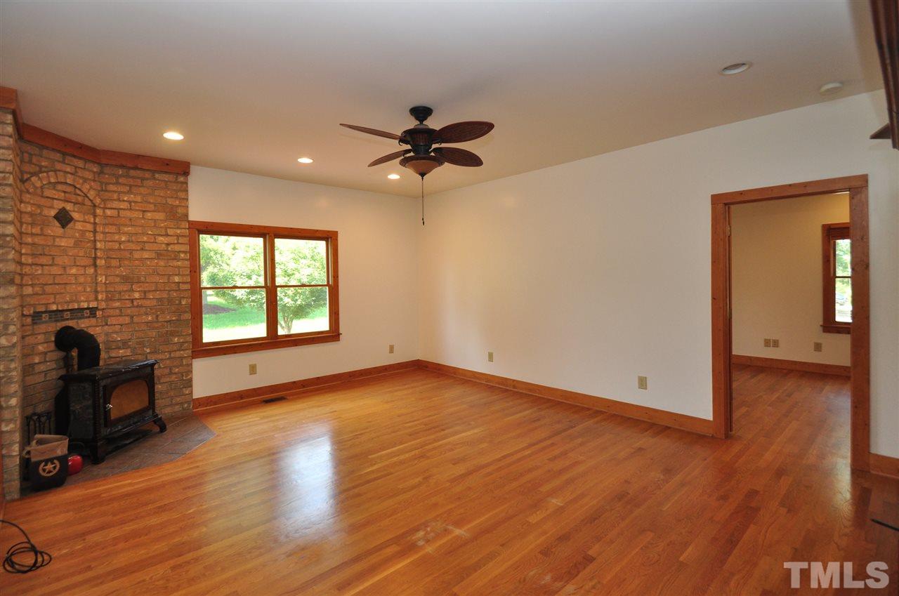 738 Castle Rock Farm Road Pittsboro, NC 27312 - Photo 9 of 25 wooden floor in an empty room with a window