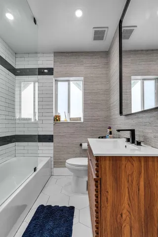 a bathroom with a sink a toilet and bathtub