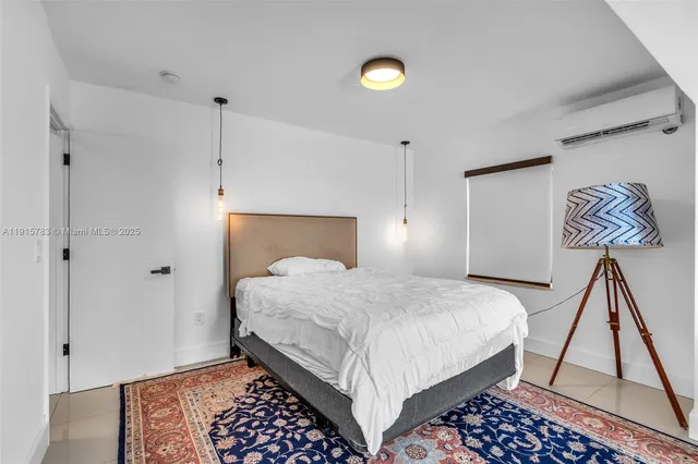 a bedroom with a bed and a night stand