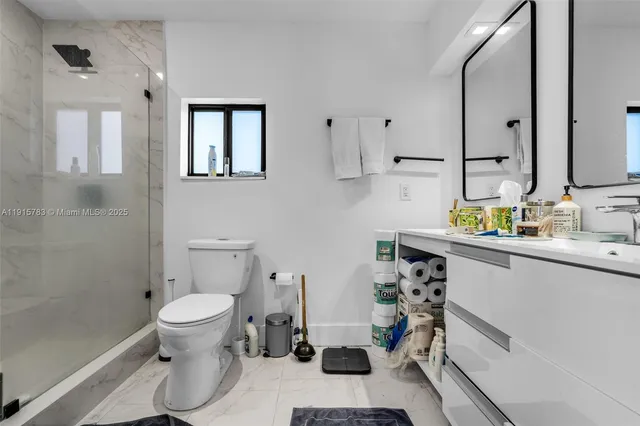 a bathroom with a sink toilet and shower