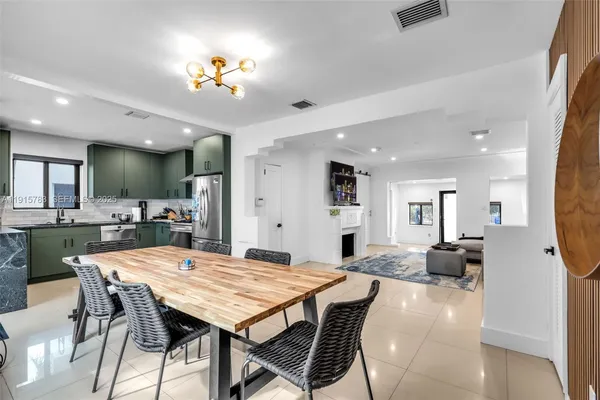 a view of a dining room with furniture and a chandelier