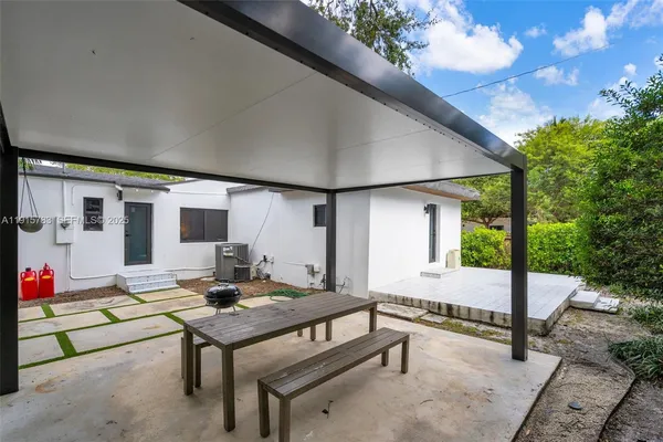 a balcony with furniture and a potted plant