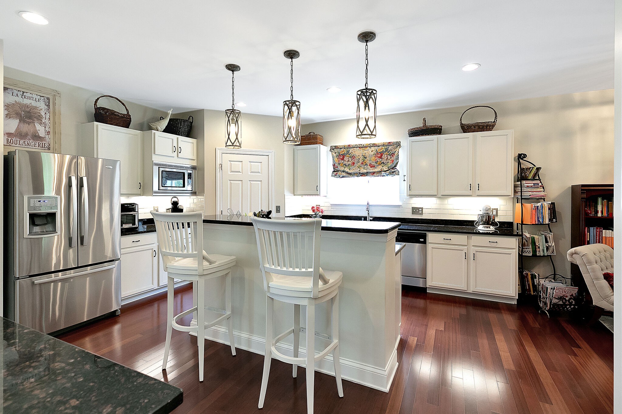 201 Verde Meadow Drive Franklin, TN 37067 - Photo 17 of 40 a kitchen with stainless steel appliances granite countertop a refrigerator a stove and white cabinets with wooden floors