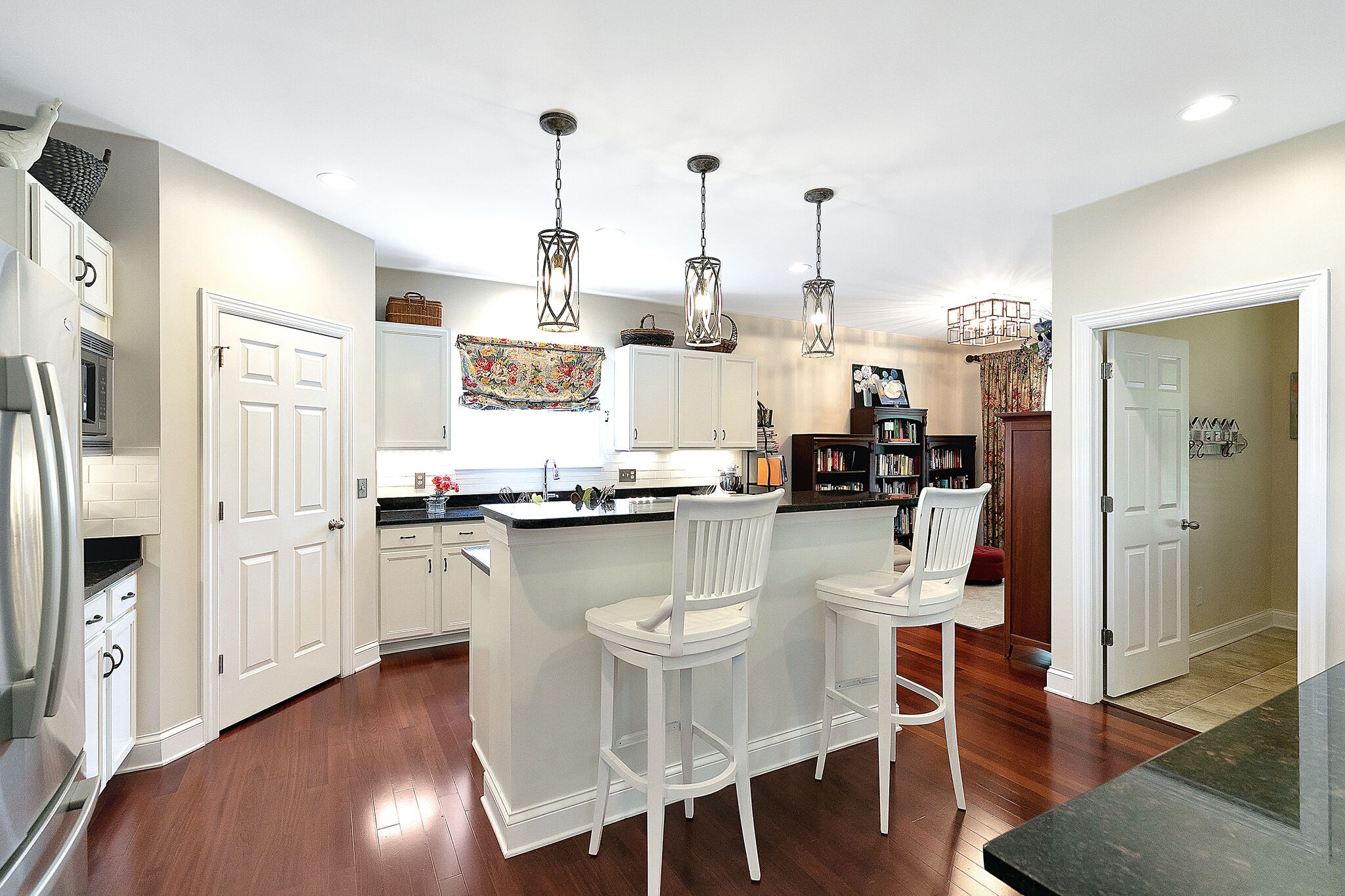 201 Verde Meadow Drive Franklin, TN 37067 - Photo 18 of 40 a kitchen with stainless steel appliances kitchen island granite countertop a refrigerator a stove and white cabinets with wooden floor