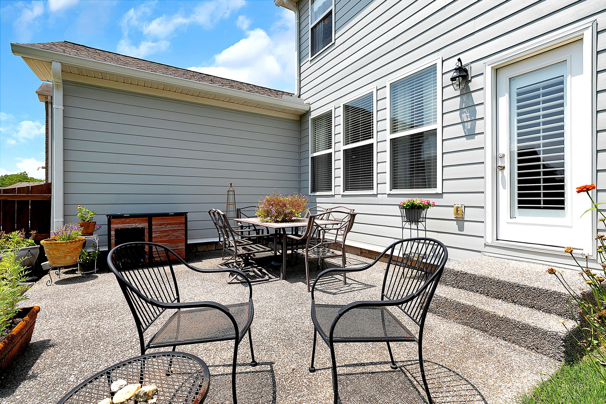 201 Verde Meadow Drive Franklin, TN 37067 - Photo 34 of 40 a view of a patio with table and chairs and floor to ceiling window