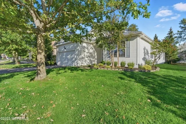 a view of a house with backyard sitting area and garden